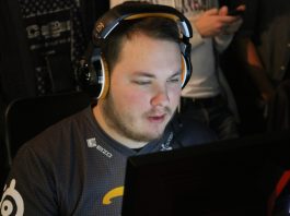 A man wearing headphones is sitting in front of a computer.