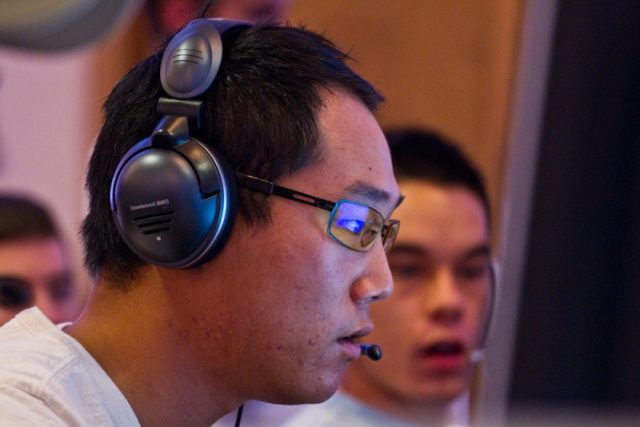 A man wearing headphones in front of a group of people.